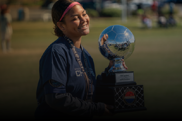 teen girl holding Premier League trophy